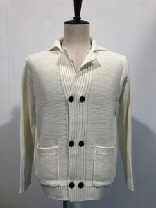 Detail of knitted cardigan showing lapel collar, black buttons and large front pockets