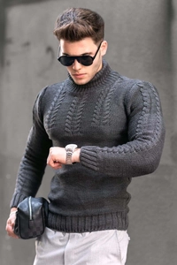 Detail view of men's dark grey cable-knit turtleneck sweater with thick wool texture