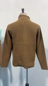 Detail view showing back of dark khaki waffle knit sweater with ribbed cuffs and hem