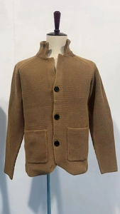 Detail of men's brown waffle knit cardigan with stand collar and large front buttons
