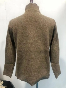 Macro detail of tan knitted men's sweater featuring thick wool texture and high collar back