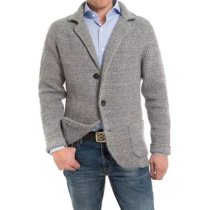 Detail of grey knitted cardigan blazer showing coarse knit texture and lapel design