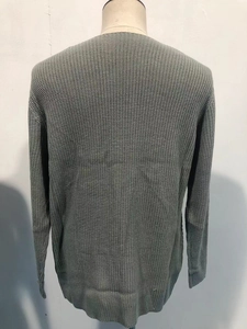 Detail of grey chunky knit sweater back view with ribbed cuffs and hem on a mannequin