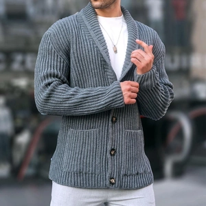 Detail of grey rib-knit cardigan featuring wood-textured buttons and functional pockets