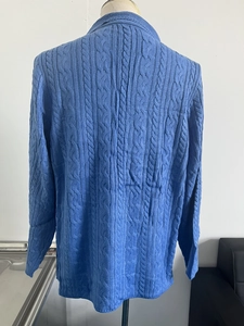 Detail view of the cable knit texture on back of the blue men's knitted cardigan