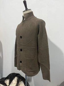Detail view of coffee brown waffle knit cardigan featuring stand collar and large buttons