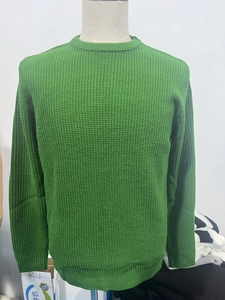 Close-up of the textured green waffle knit fabric on this men's crewneck sweater