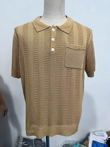 Detail of tan short sleeve knit polo shirt featuring vertical stripes and a chest pocket
