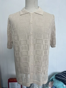 Detail of men's beige knitted polo shirt with geometric cutout and buttoned collar