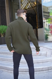 Detail of olive green knit cardigan featuring thick vertical ribbed texture and slim fit