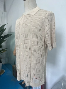 Detail of hollow crochet knit texture and button placket on men's short sleeve polo shirt