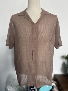 Detail of men's brown short sleeve knit shirt with breathable mesh hollow texture