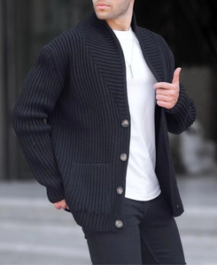 Detail of men's heavy knit cardigan featuring textured geometric patterns and buttons