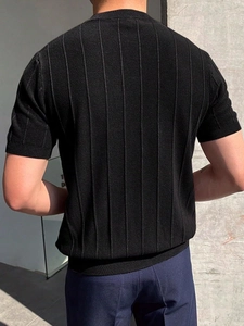 Close-up of the black ribbed knit texture and sleeve detail on a men's summer t-shirt