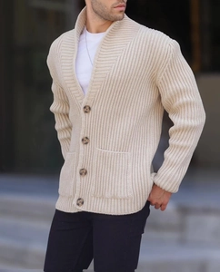 Detail view of cream knit cardigan with thick ribbed texture and tortoiseshell buttons