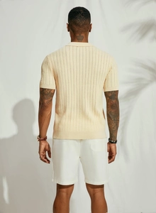 Detailed back view of a cream knit polo shirt featuring vertical textured stripes
