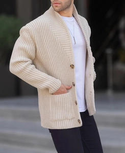 Close-up of men's beige knitted cardigan showing vertical stripes and horn buttons
