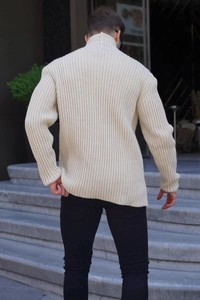 Outdoor back view of men's ribbed knit beige sweater with thick texture and high collar