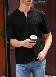 Detail showing wave pattern knit texture on black short sleeve polo shirt for men