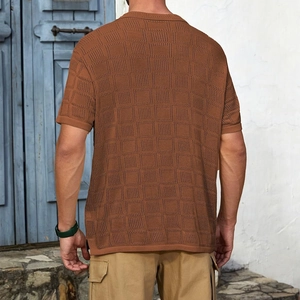 Detail of rust brown knitted short sleeve shirt with waffle texture and ribbed cuffs