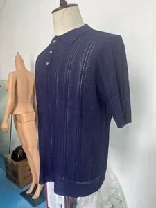 Detail of navy blue knitted polo shirt featuring vertical hollow breathable texture