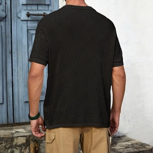 Detail of men's black knit shirt showing back view and textured checkerboard weave pattern