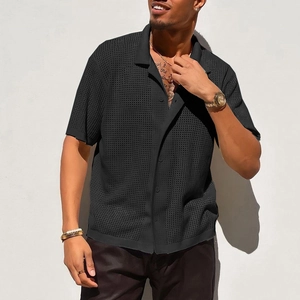 Close-up of black breathable mesh knit polo shirt showing textured hollow-out fabric detail