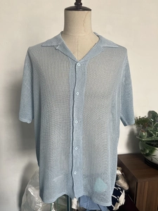 Close-up of light blue short sleeve knit shirt with breathable mesh and cuban collar