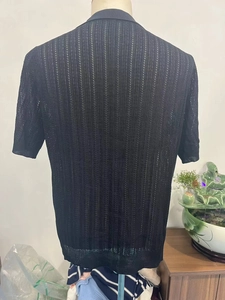 Rear view of black knit short sleeve polo shirt with vertical hollow stripe texture