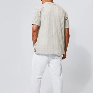 Detail of hollow knit texture on the back of a beige men's short-sleeved polo shirt