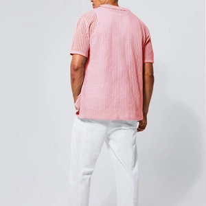 Rear view of pink knitted polo shirt showing breathable openwork crochet texture