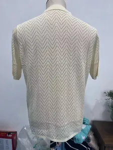 Detail view showing the zigzag hollow knit pattern on the back of this cream polo shirt
