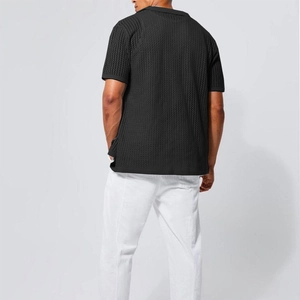 Rear view of men's black knit polo shirt featuring waffle texture and casual slim fit