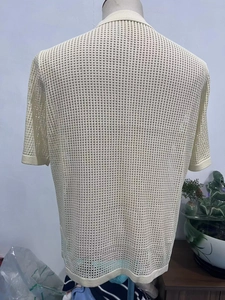 Close-up of beige knitted polo shirt featuring breathable mesh hollow-out texture