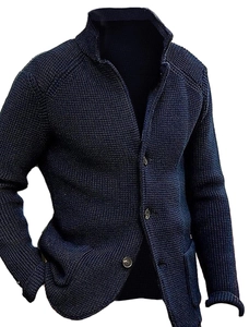 Detail view of navy knit cardigan with textured waffle weave and metallic buttons