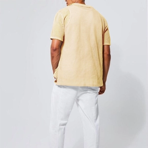 Macro shot showing the breathable geometric mesh knit texture of the beige short sleeve shirt