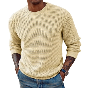 Detailed close-up of beige men's waffle knit sweater featuring textured ribbing on cuffs