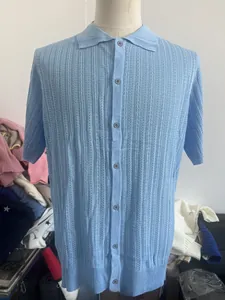 Macro detail of men's knit polo shirt featuring vertical hollow knit texture in light blue