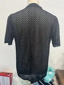 Detailed view of the hollow wave zigzag knit texture on a black summer polo shirt