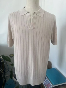 Detailed knit texture of light beige men's mesh polo shirt with striped hollow-out pattern