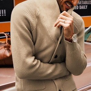 Close-up of beige knit cardigan showing shawl collar and honeycomb textured fabric details