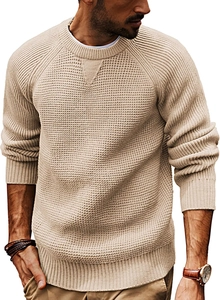 Detailed view of the apricot knitted sweater neckline with ribbed texture and triangle detail
