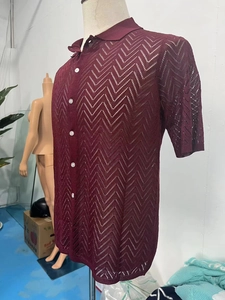 Close-up of hollow out knit texture and button detail on burgundy polo shirt