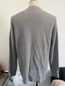 Rear view of grey knit sweater for men featuring breathable waffle texture on a mannequin
