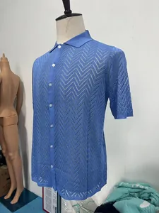 Detailed close-up of blue short sleeve knit polo shirt with hollow wave pattern