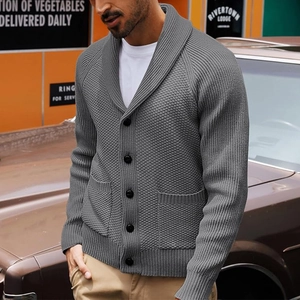 Detail of grey men's shawl collar knit cardigan showing textured fabric and buttons