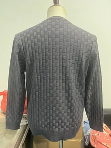 Detailed back view of dark grey men's knit sweater featuring textured checkerboard pattern