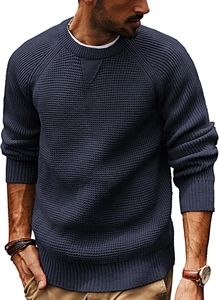 Detail of dark blue knit sweater showing coarse knit texture and crew neck with stitching