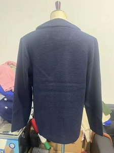 Detail view of navy blue waffle knit texture on men's vintage cardigan back