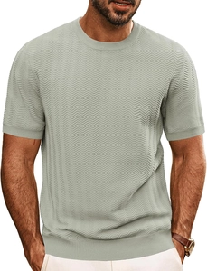 Close-up of sage green knit t-shirt featuring textured wave pattern and ribbed cuffs